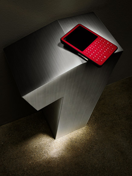 Peek handheld email device displayed on a brushed metal pedestal